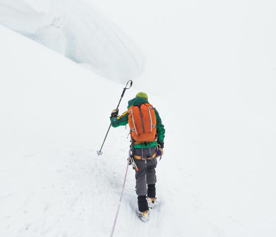 person hikes in deep snow