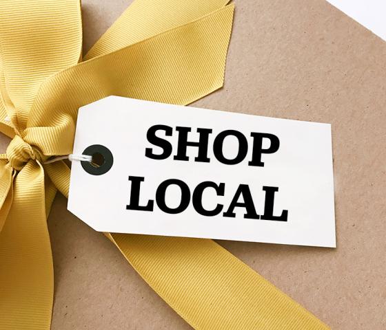 Image of a gift with a tag that says "Shop Local"