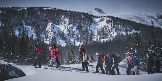 people hiking in the snow